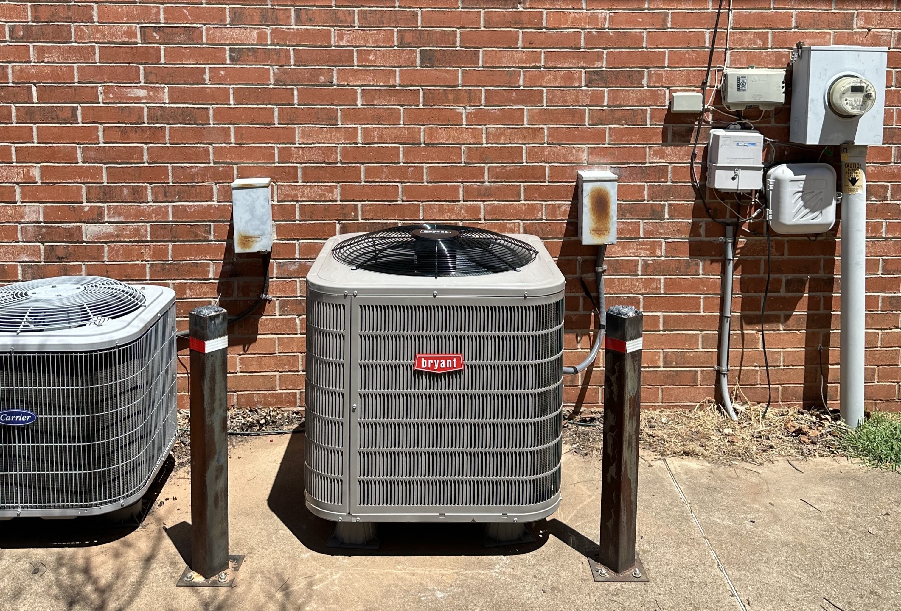 HVAC repair technician using a power drill to fix an air conditioning compressor unit, with tools scattered nearby for repair work.